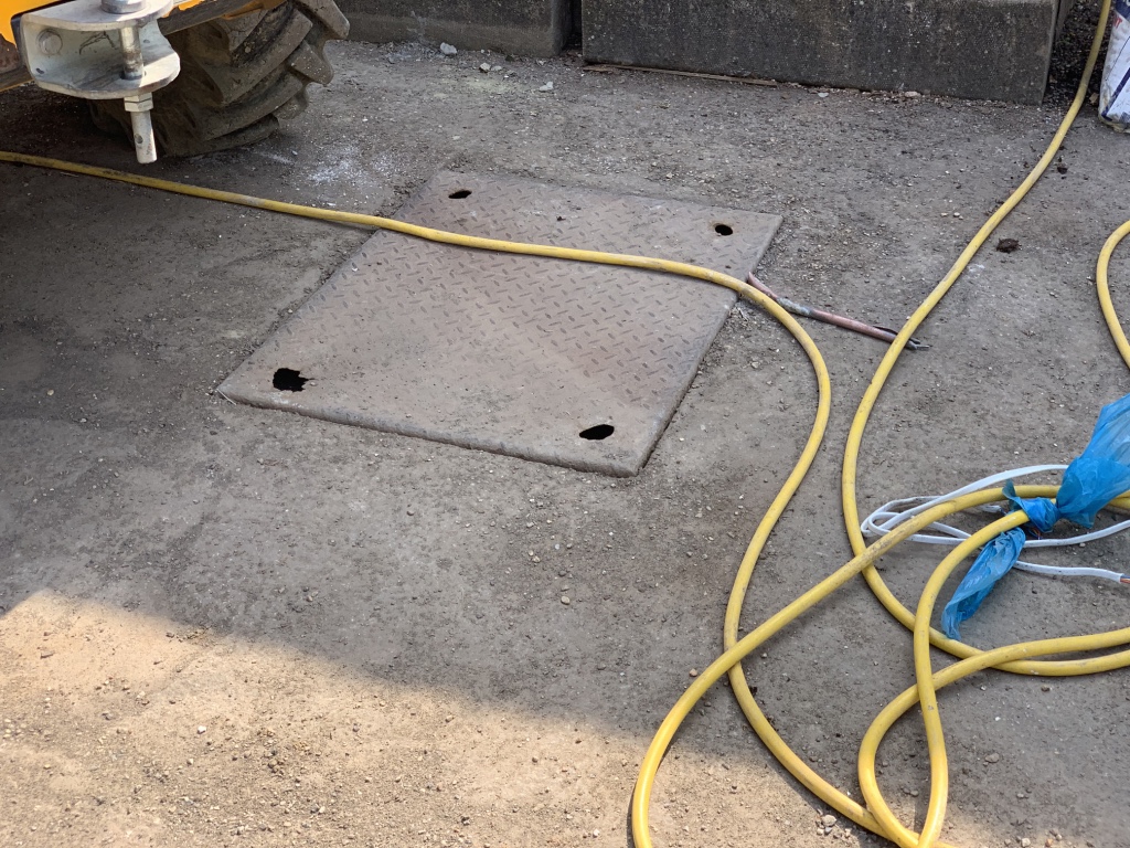 A poorly fitted steel plate of a treatment plant inspection chamber.