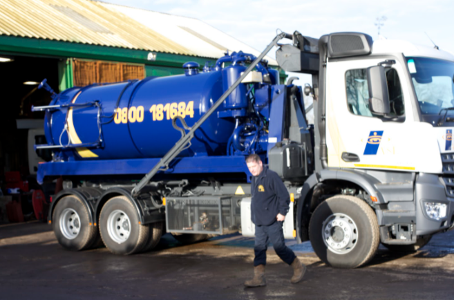 A photo of Ken with the ASL Limited sewage tanker.