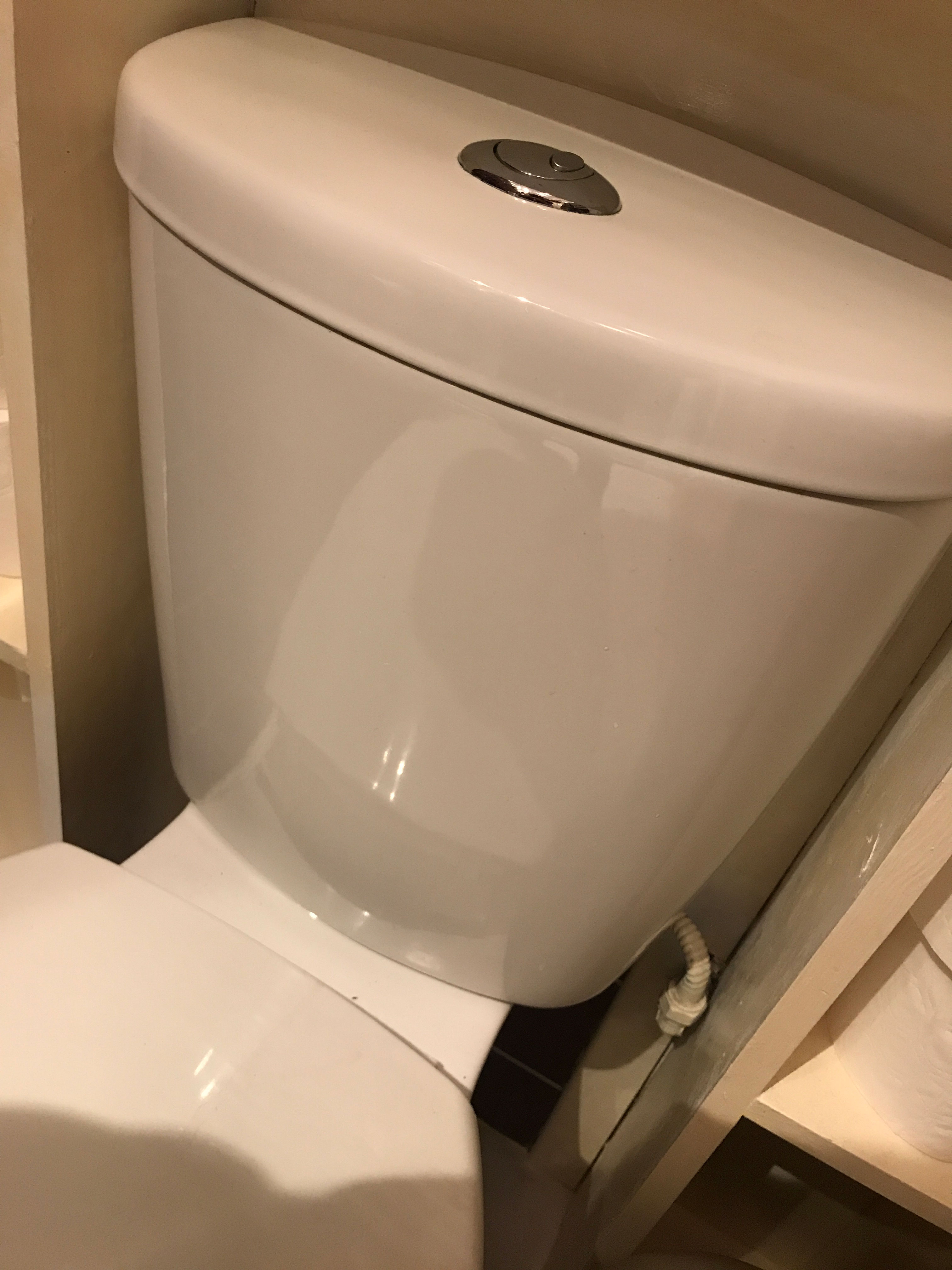 A photo of a household toilet that produces wastewater when you flush