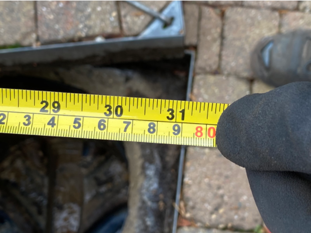 An image of a tape measure being used onsite.