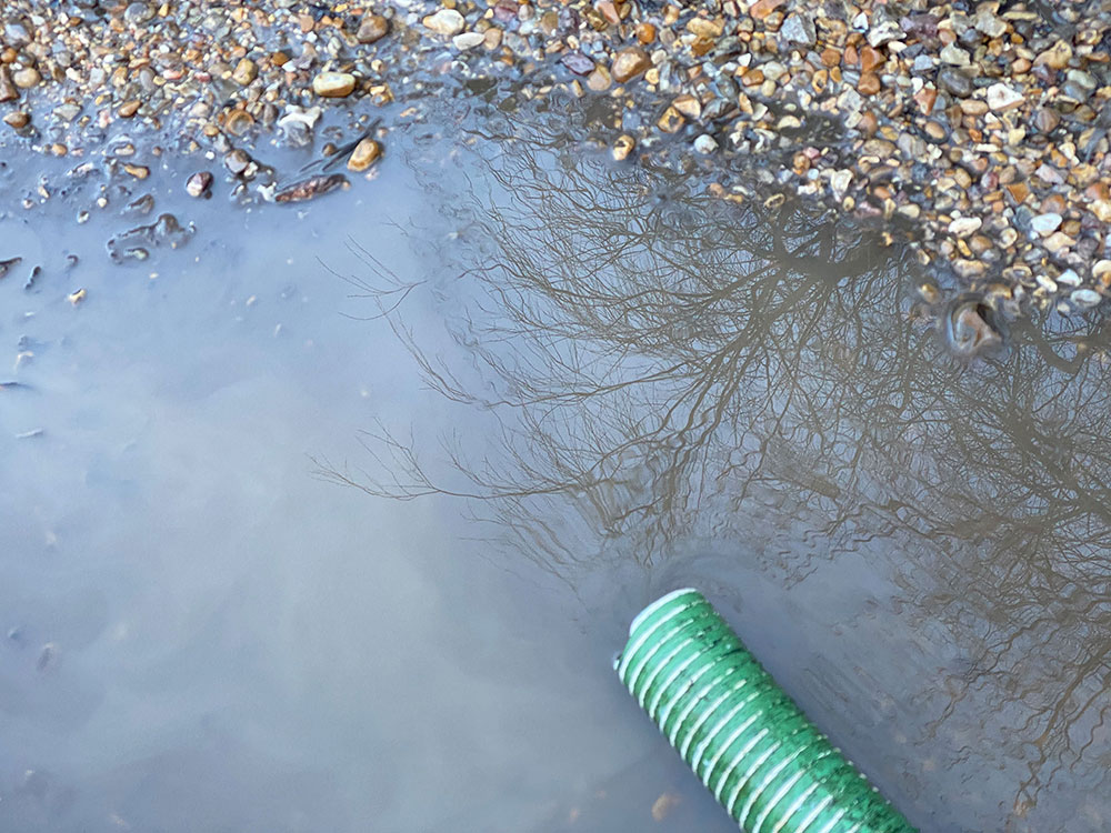 A photo of a blocked pump spilled over onto the driveway.