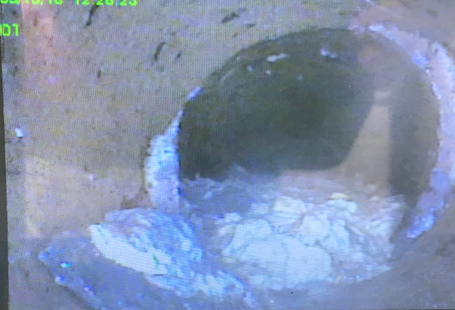 CCTV image showing a drain blocked with fat and grease