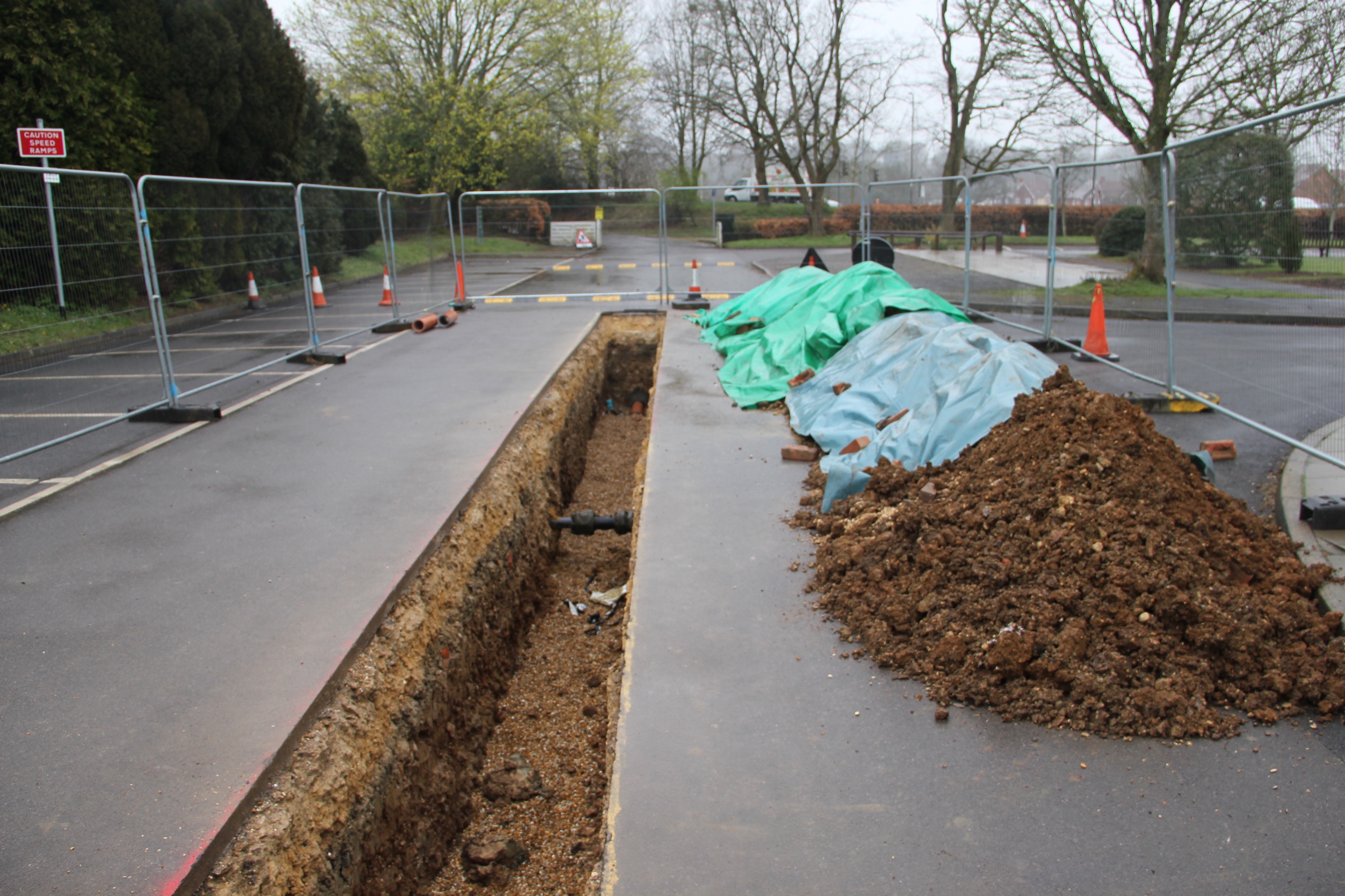 Cutting concrete to lay new drainage pipework and making good on the groundwork