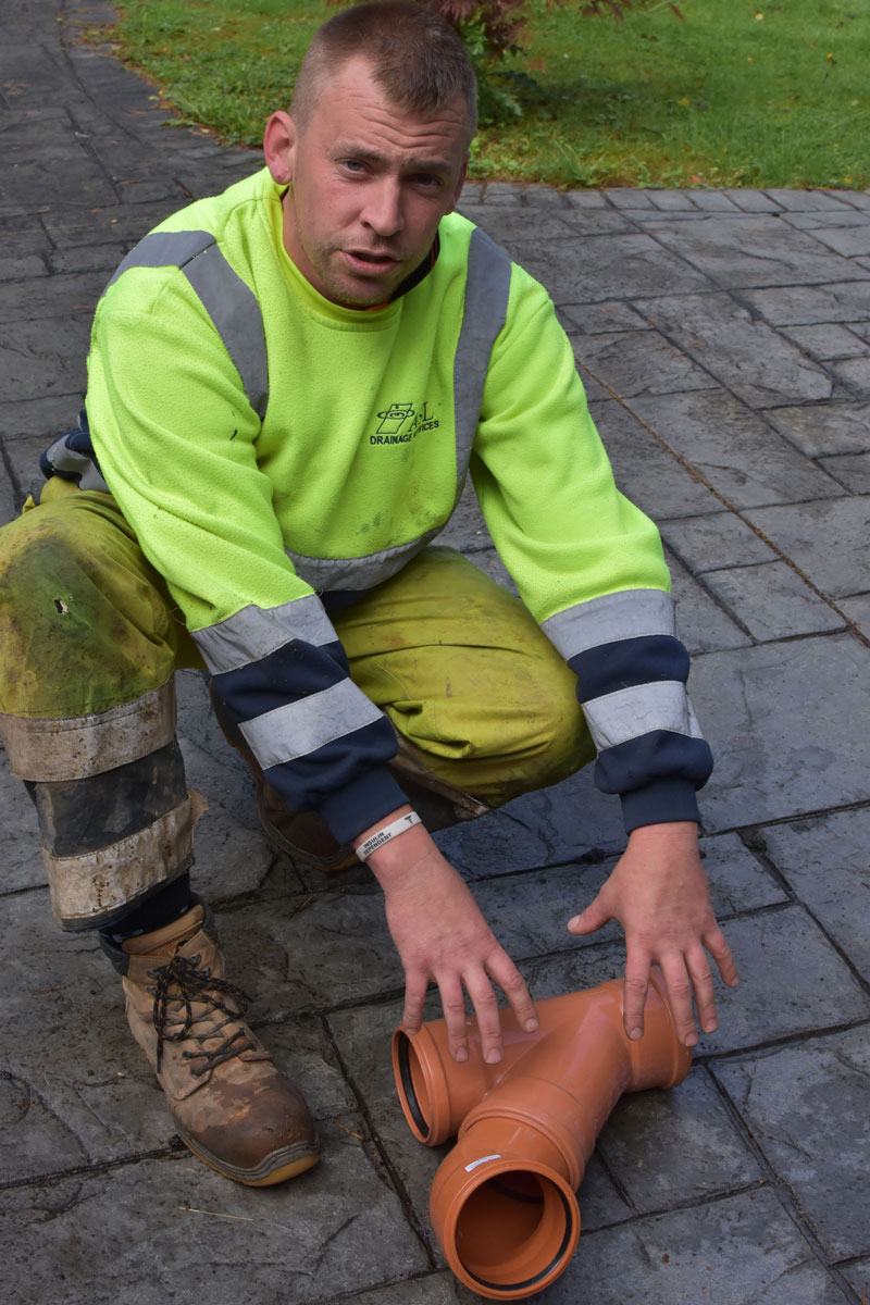 This is a photo of our Liam explaining what angles should have been used in the drain connection and why the back up is occurring.