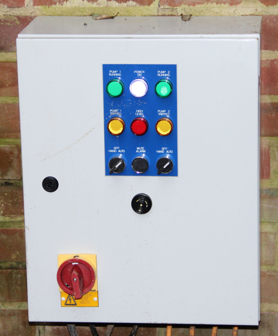 A photo of a pumping station alarm system located in the garage.