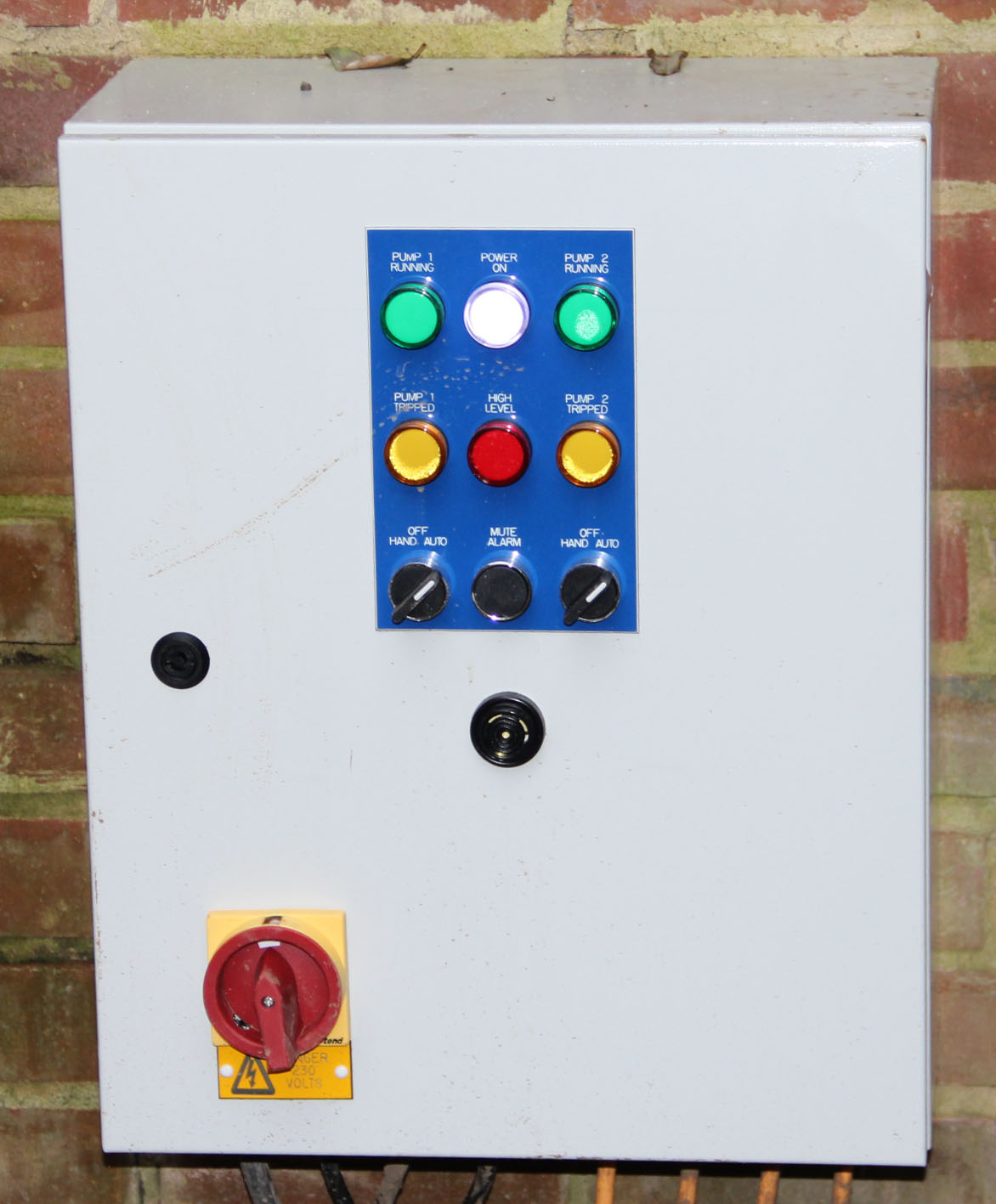 A photo of a pumping station alarm system located in the garage.