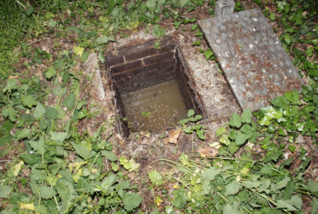 This is a photo of a manhole/inspection chamber that repeatedly fills up due to the blocked drain.