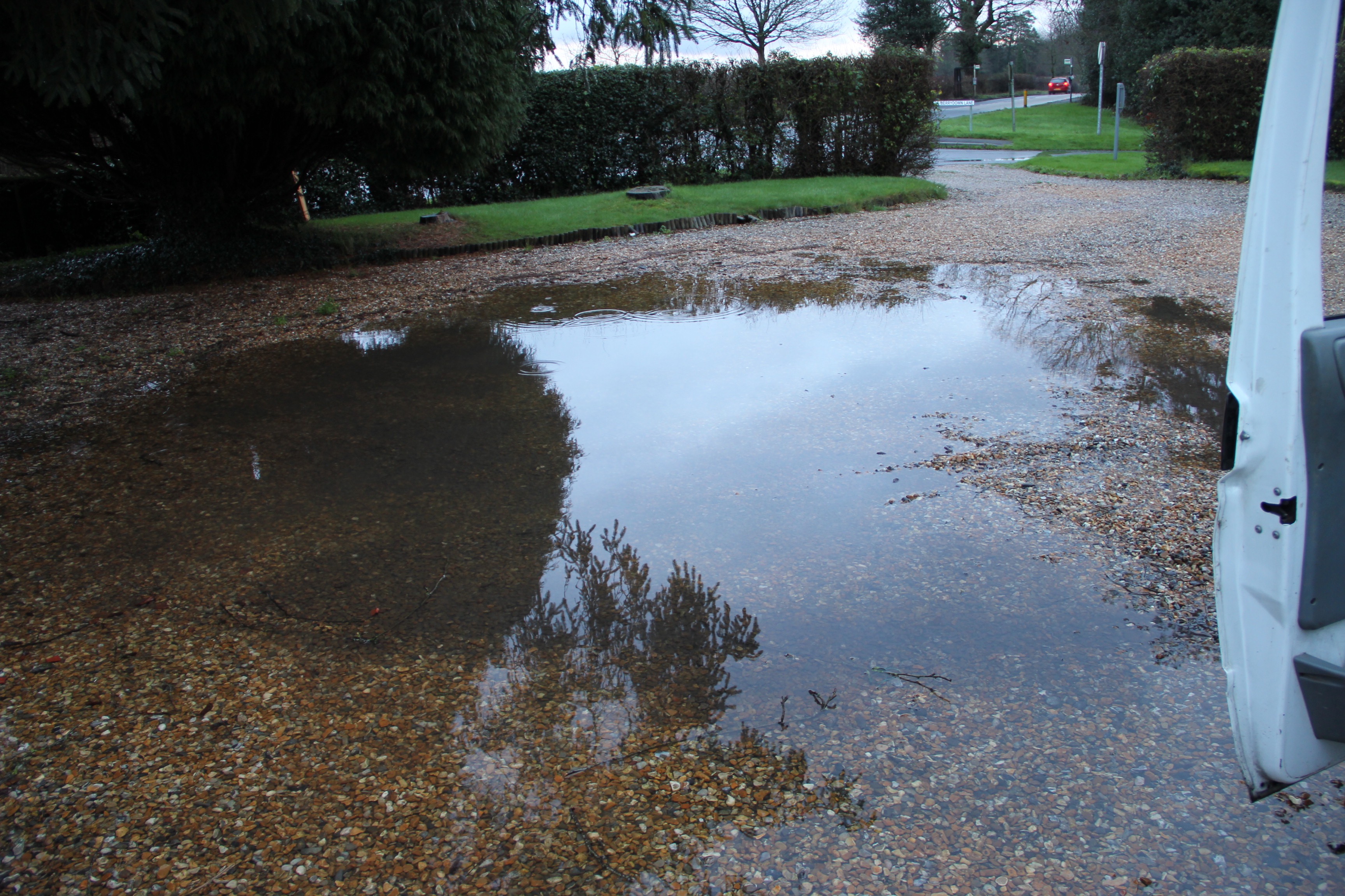 This image shows standing water ponding on a drive.