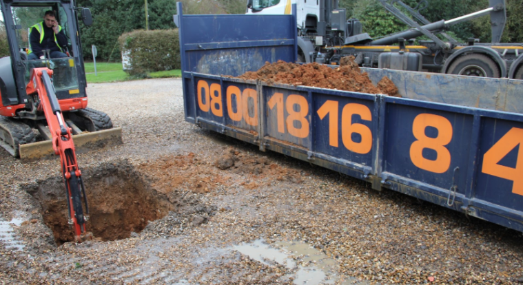 This image shows a 1.5m square hole dug to create the drainage. The red clay makes drainage impossible.