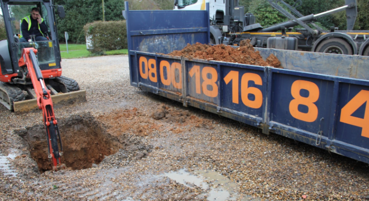 This image shows ASL Limited digging a hole to create driveway drainage.