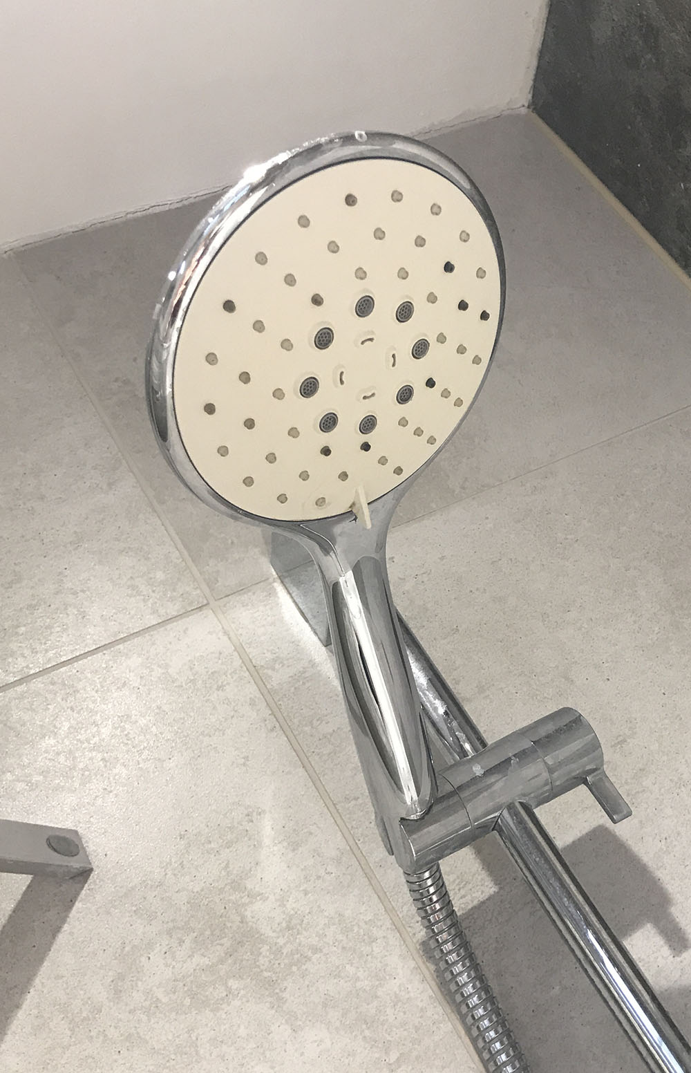 This image shows a shower with a drain that needs unblocking.