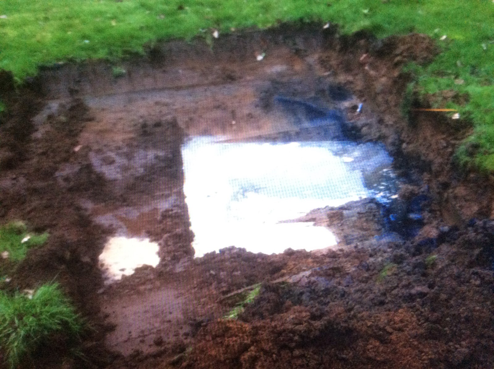 This is a photo of blackened water as a result of the grounds inability to soak away the water..