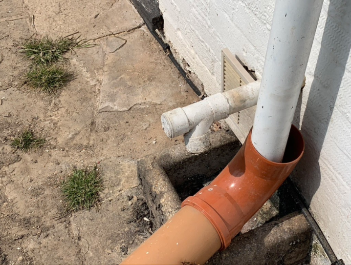 This image shows a temporary set up to avoid the surface water from the down pipe flowing into the waste system