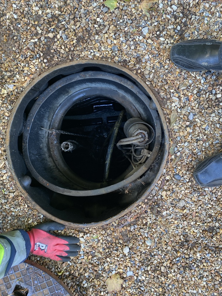 This image shows the view down into the inspection chamber of the old septic tank