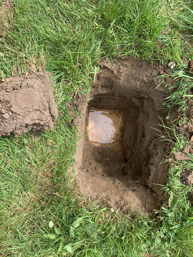 A test hole dug during porosity testing to establish if the ground is suitable for a drainage field.