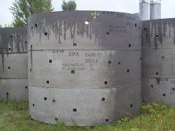 A photo of the concrete rings used to build rainwater soakaways.