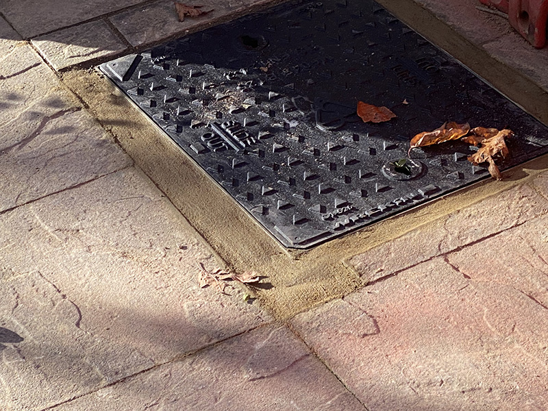 This is a picture of a manhole cover sealed to prevent surface water draining into the private sewage system.