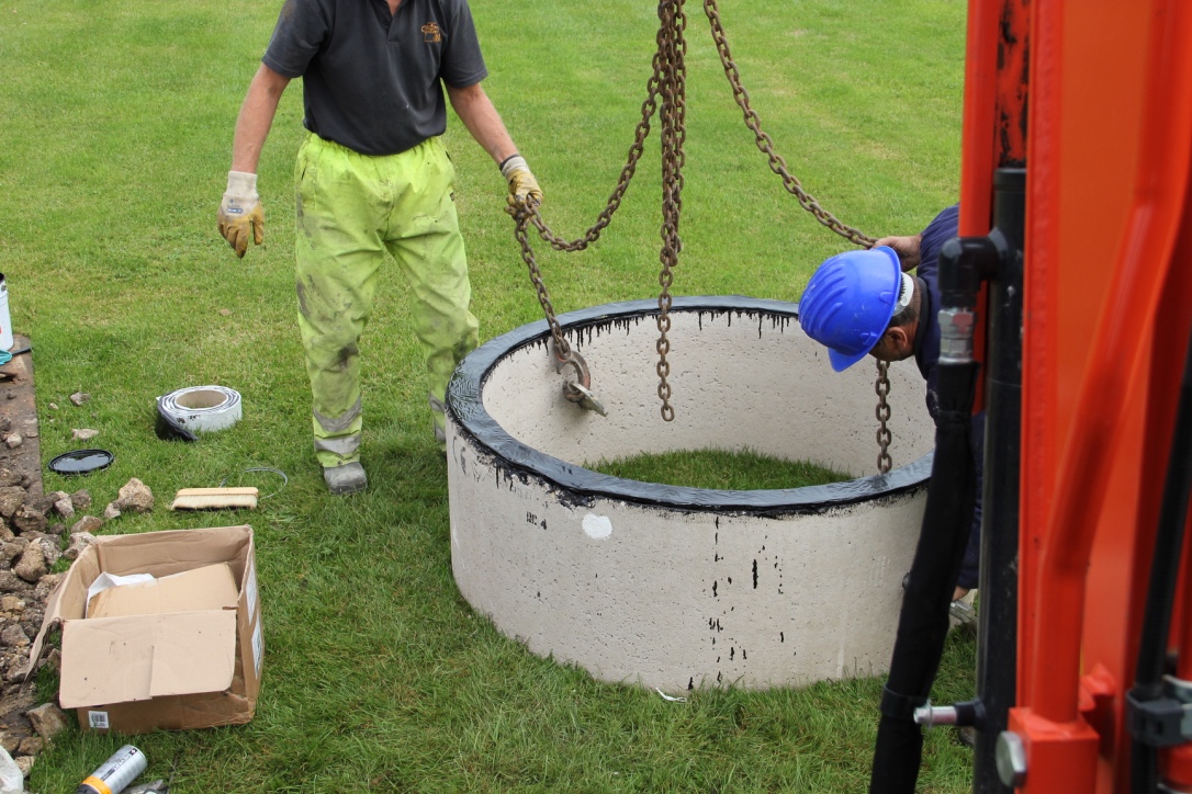 Concrete soakaway rings used in a surface water drainage pit.