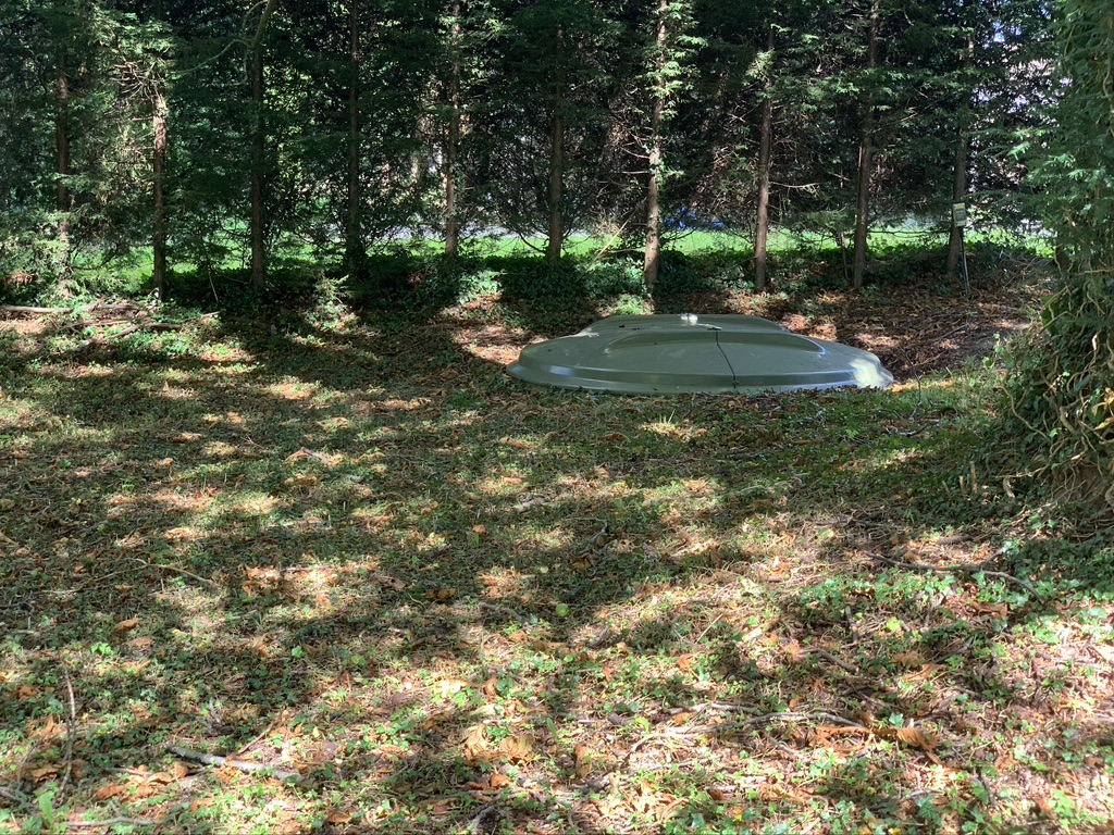 A treatment plant inspection chamber hatch visible at ground level.