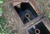 An image of a septic tank with the utility covers off so you can see the dip pipes.