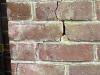 A crack in the wall of a house due to subsidence caused by a blocked drain.