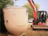 A septic tank being lifted into place during an installation.