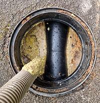 A pub's grease trap being emptied.