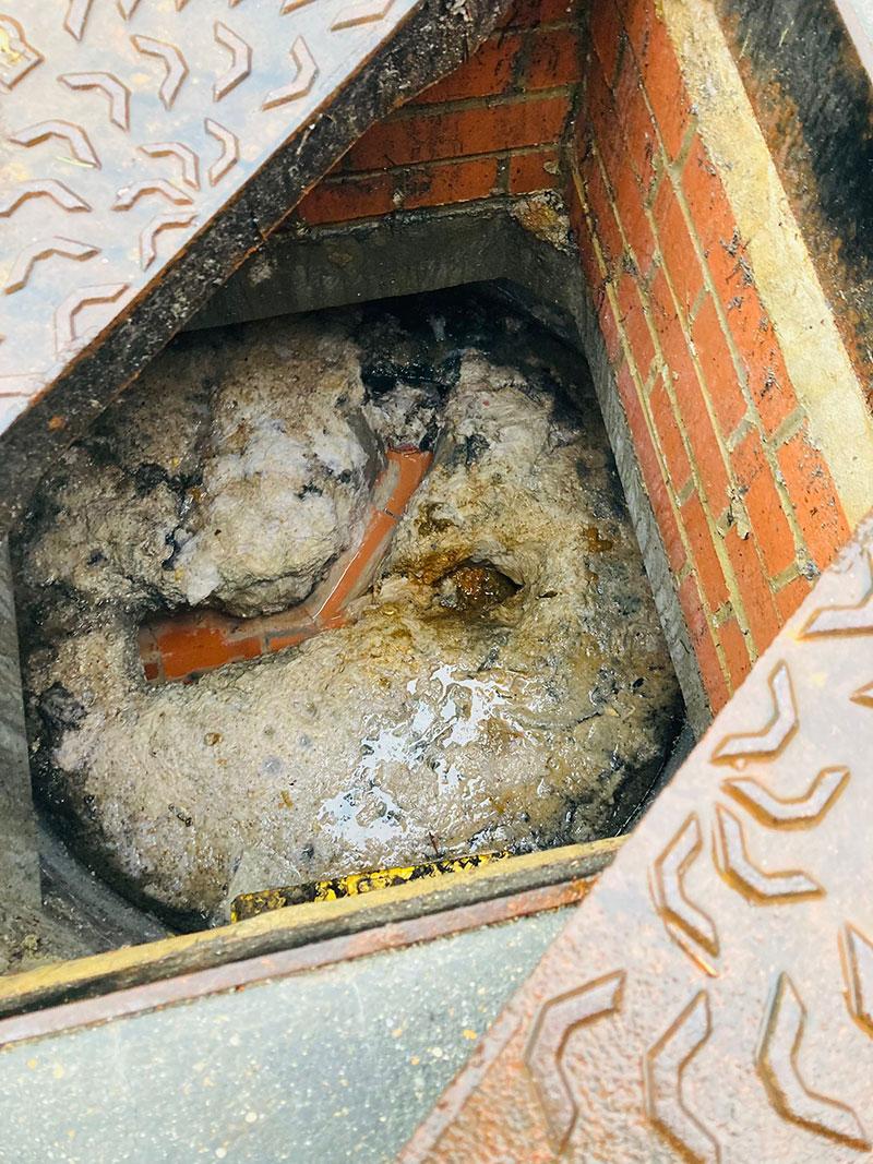 An inspection chamber congealed with fat and grease