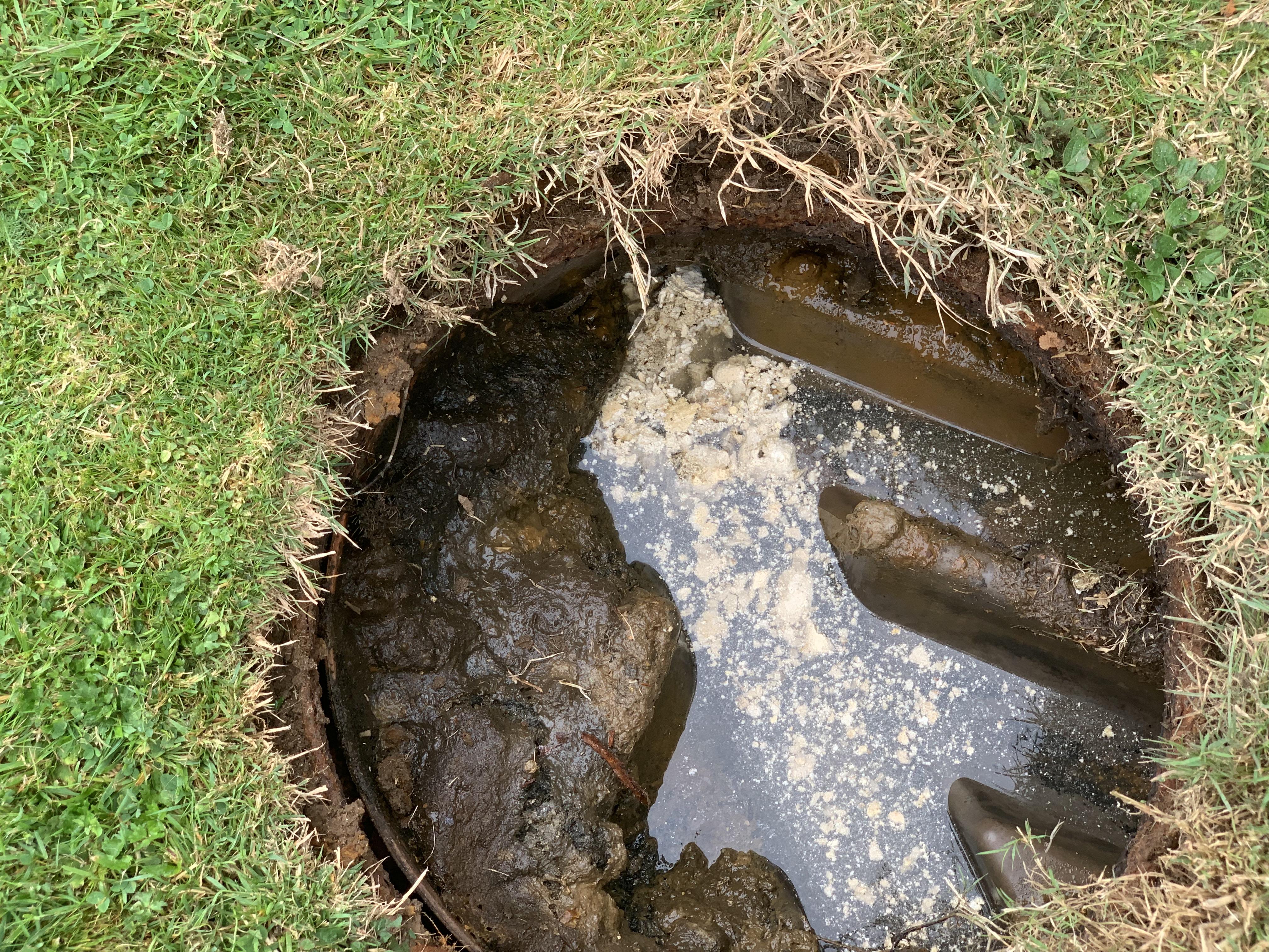 Water ponding in the inspection chamber of a septic tank.