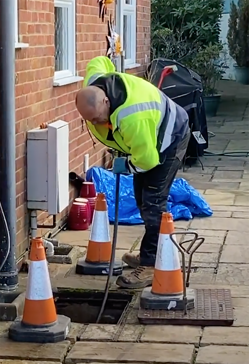This is a photo of our Darren using drain rods to unblock a blocked drain in Guildford, Surrey