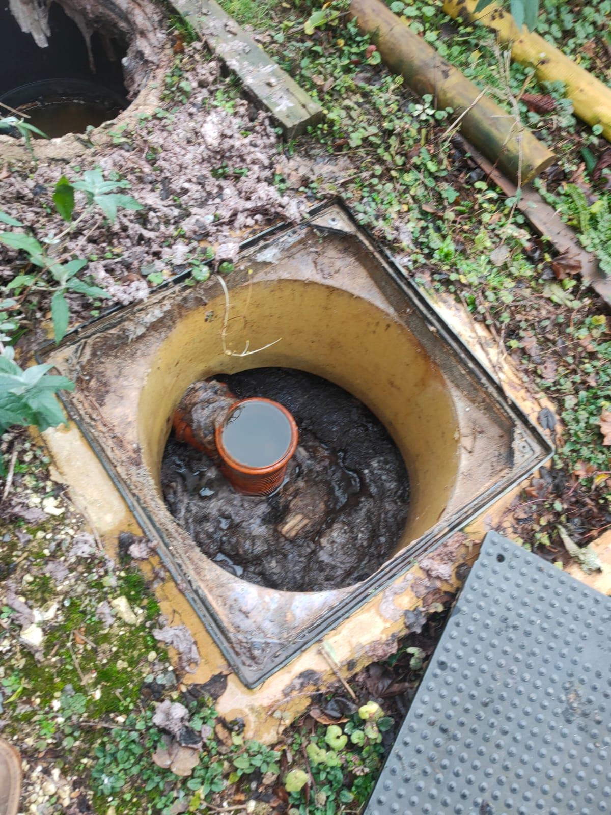 A holding tank before a treatment plant backed up with solids encrusted at the top.