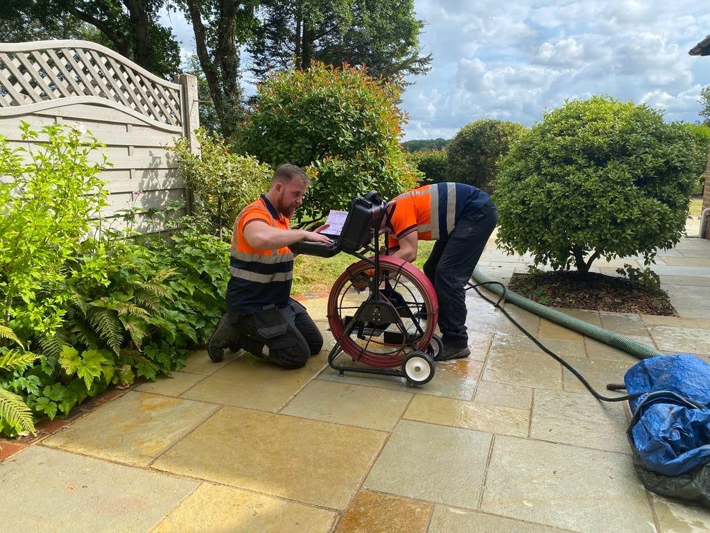 engineers conducting a house drain survey