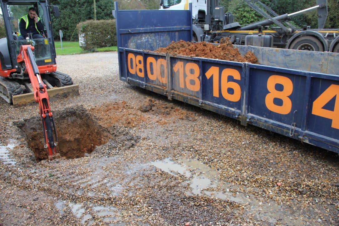 digger excavating for a drain repair