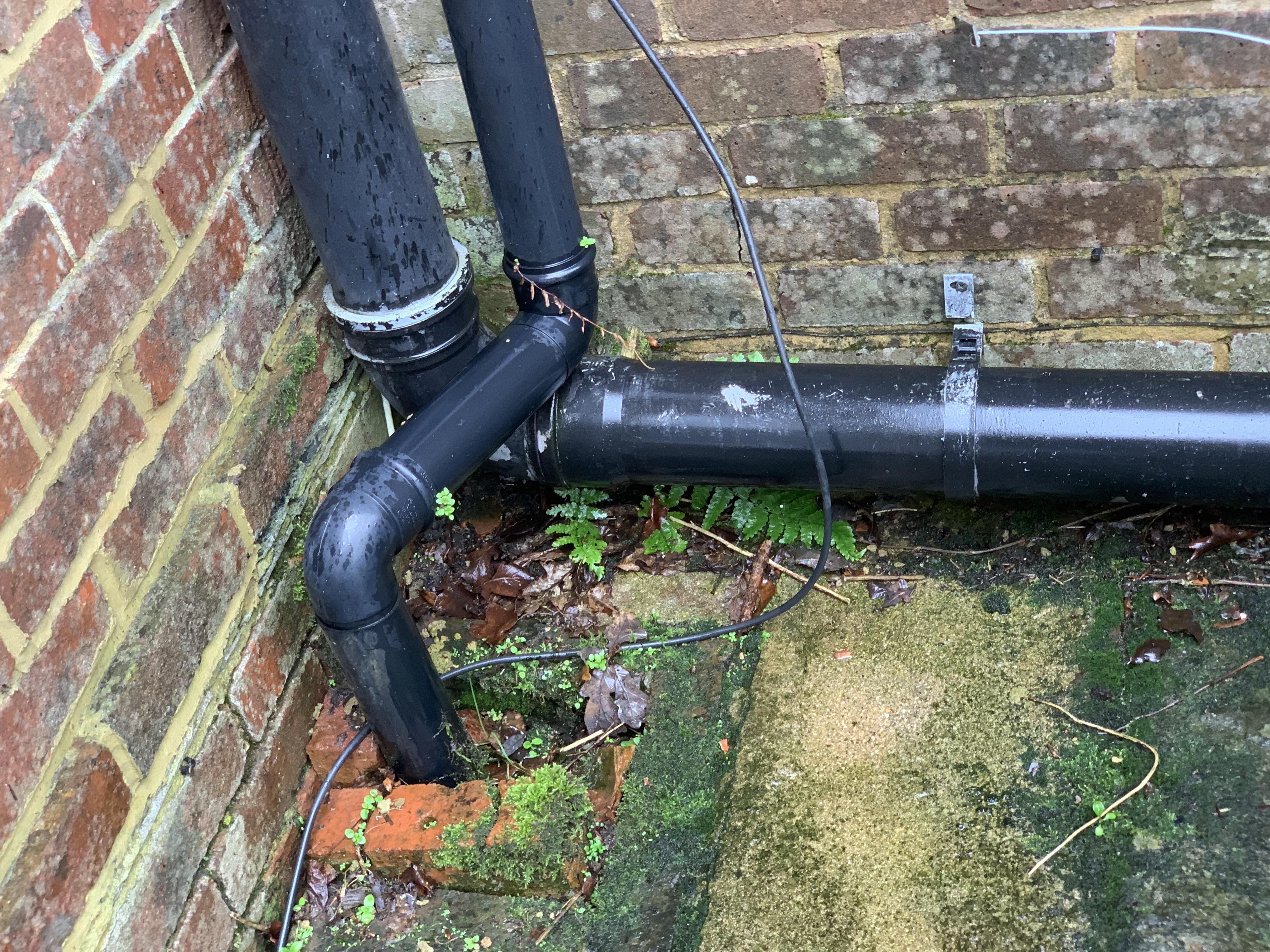 An image of a blocked rainwater drain on a domestic property