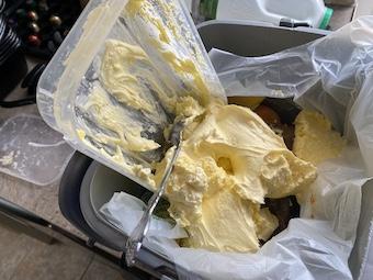 Fat being scraped in the food waste bin instead of washed down the drain!