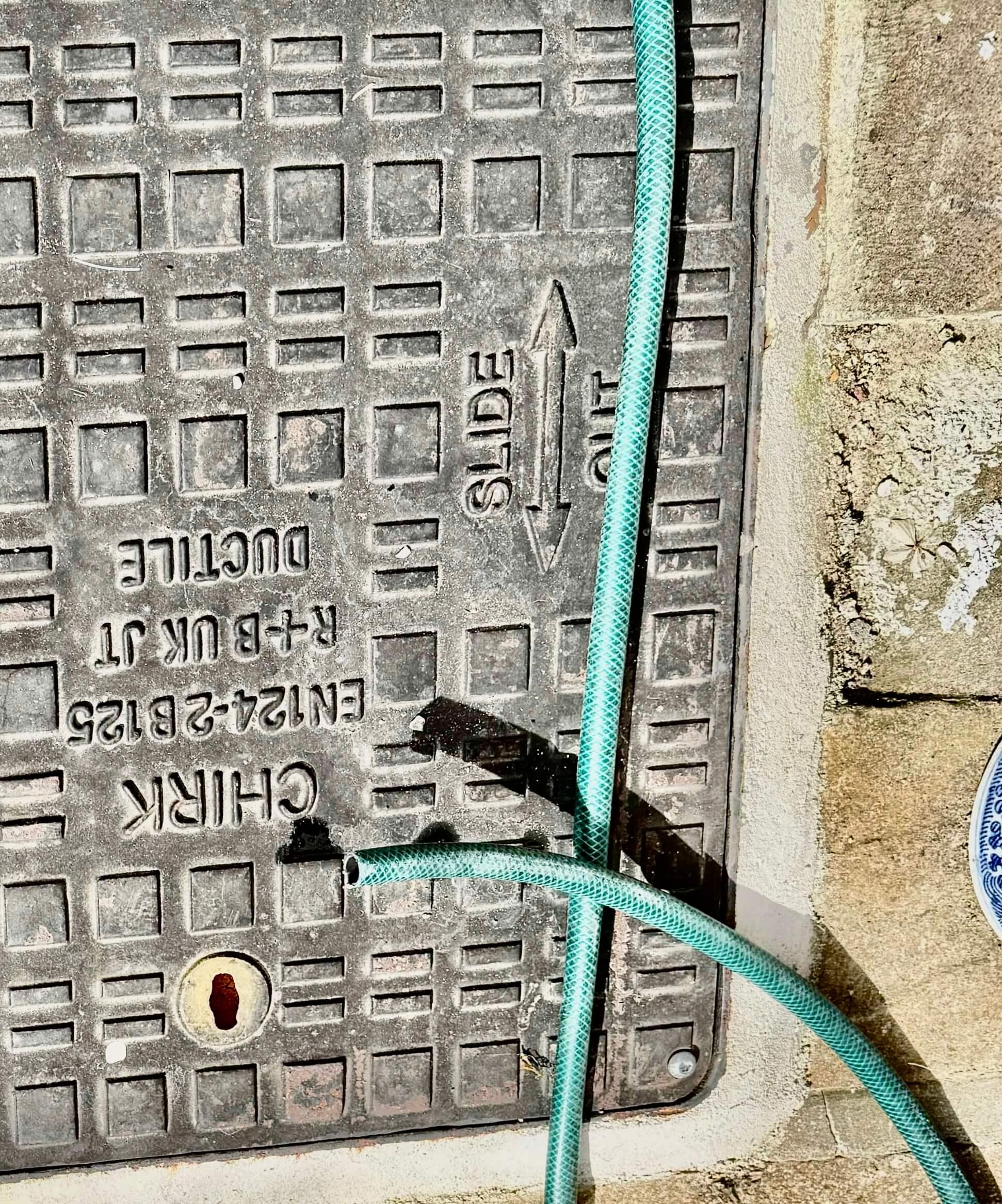 An image of an inspection chamber being tested for leaks into the private sewage system in Merrow, Surrey.