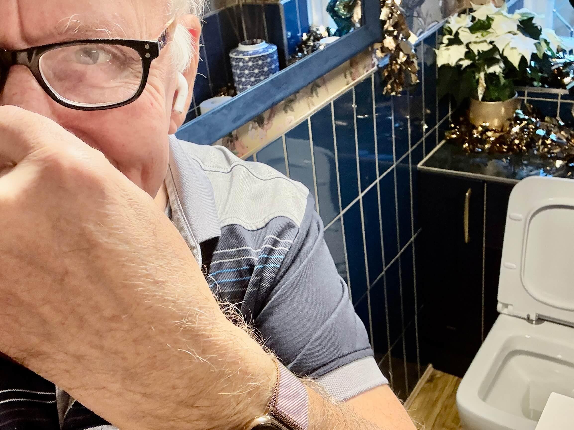 This is an image of our Gerry pinching his nose by a smelly toilet!